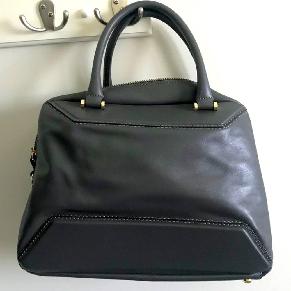 This bag is made of 100% Italian Leather. Dark grey.Gold zipper.